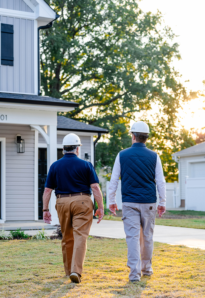 William Elmore and Billy Elmore walking towards a house they built