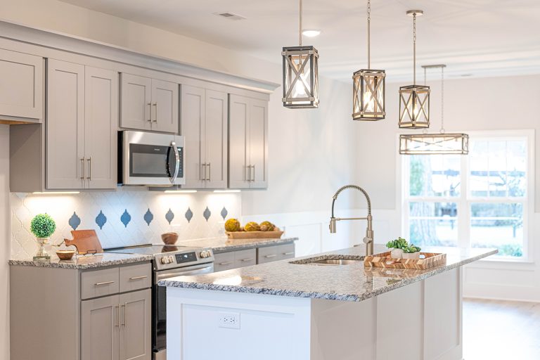 Bright kitchen with luxury fixtures and finishes built by Elmore Builders